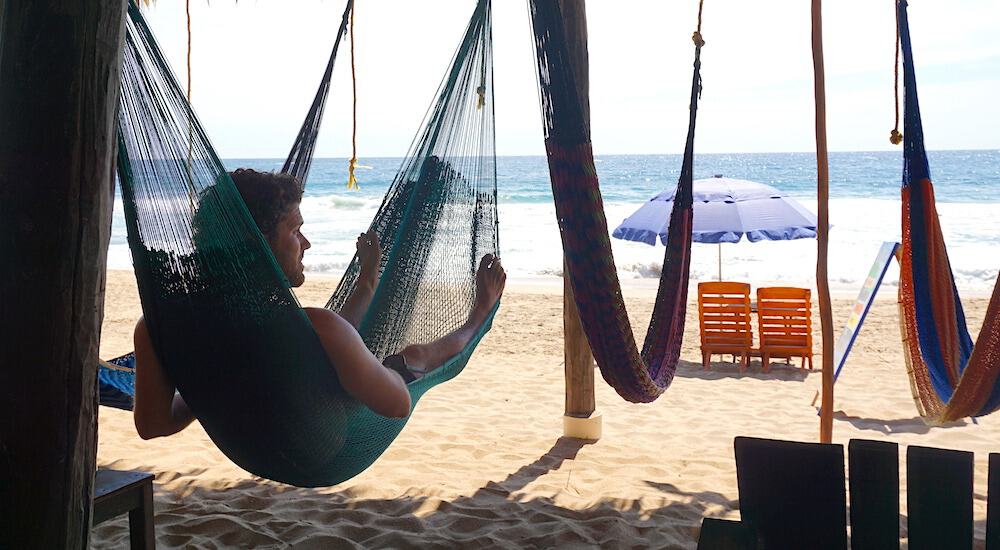 Michael from Off Path Travels hanging out on Playa Zipolite in a hammock