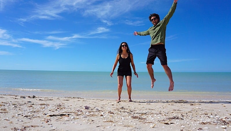 Michael and Kristina trying to time a picture together on the beach in Celestun