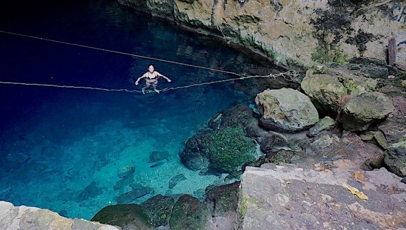 Kristina from Off Path Travels hanging out on the rope at Chelentun in Cenotes Chunkanán