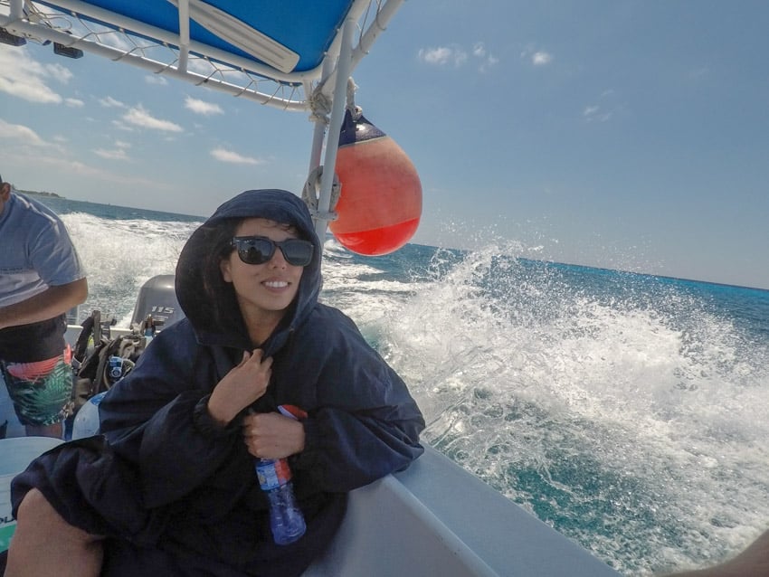 Kristina from Off Path Travels on the Aldora dive boat in Cozumel mexico wearing a warm jacket they provide