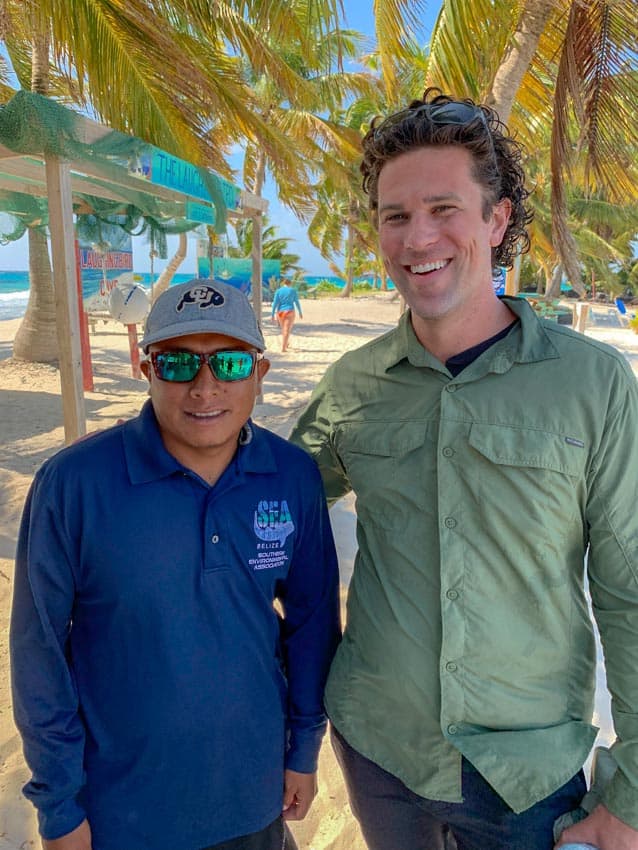 Michael with a park ranger wearing a hat from the University of Colorado