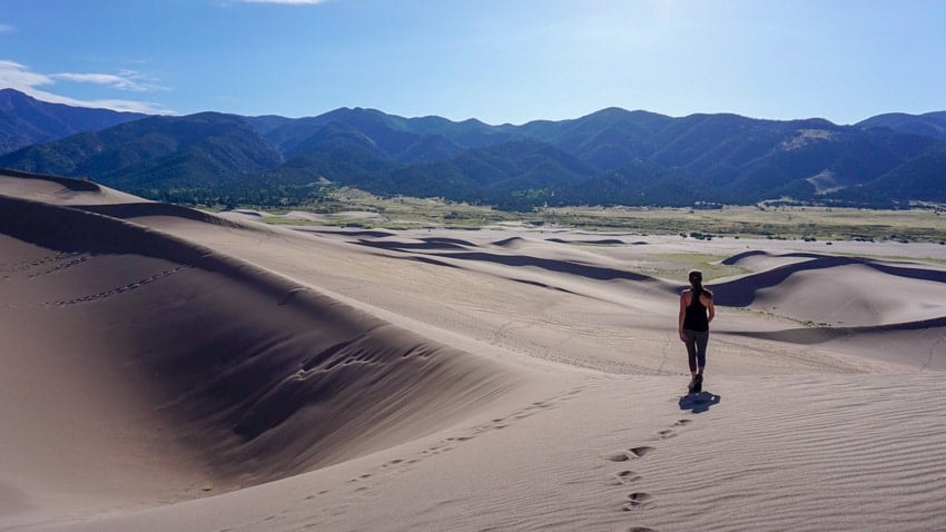 Kristina hiking in the Great Sand Dunes, looking back toward the Pinon Flats Campground