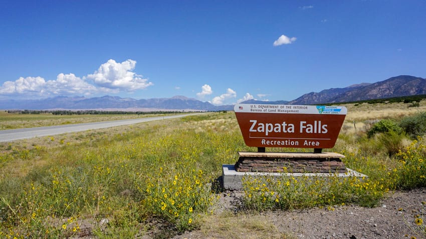 The sign for Zapata Falls, a BLM-owned campground and waterfall just up the road from the Great Sand Dunes National Park