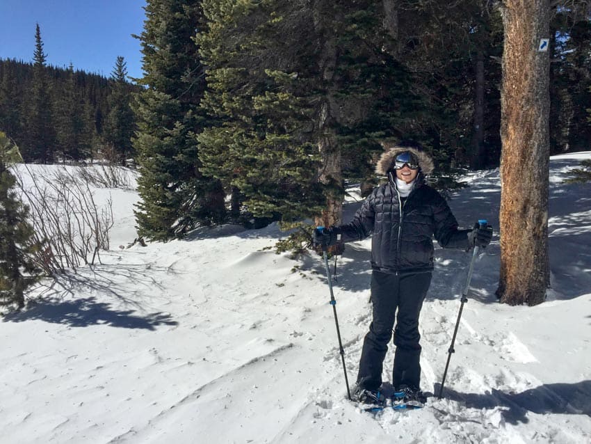 Kristina enjoying a hike through the woods on her snowshoes