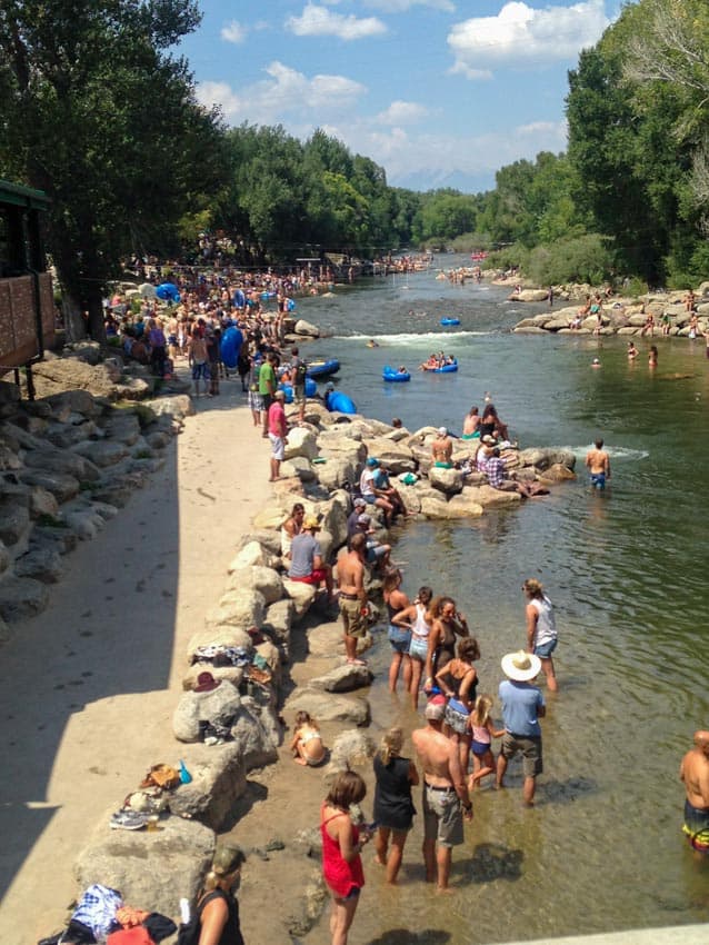 A crowded day in Salida, Colorado with plenty of people having fun on the water at a kayak tournament