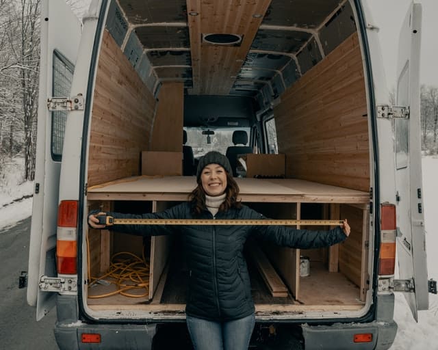 A happy camper working on building out an older model Mercedes Sprinter van.