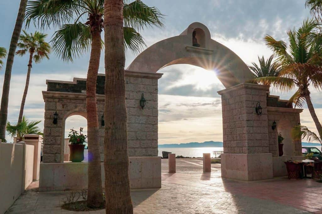 Archway in Loreto with a view of sunrise over water