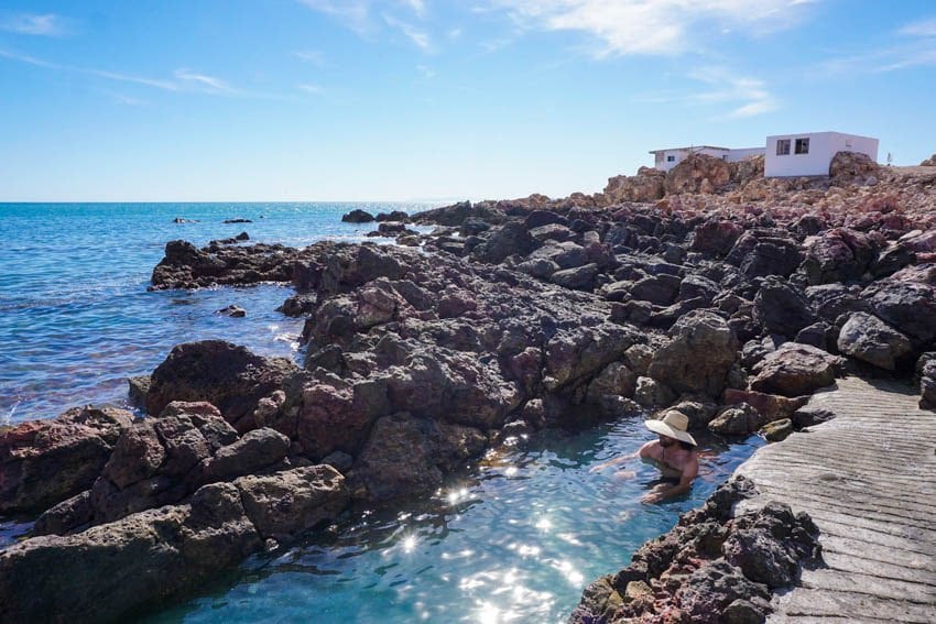 Man sitting in Puertecitos hot springs by the sea