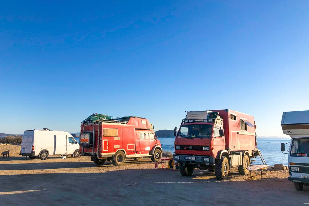 a row of campers on the beach