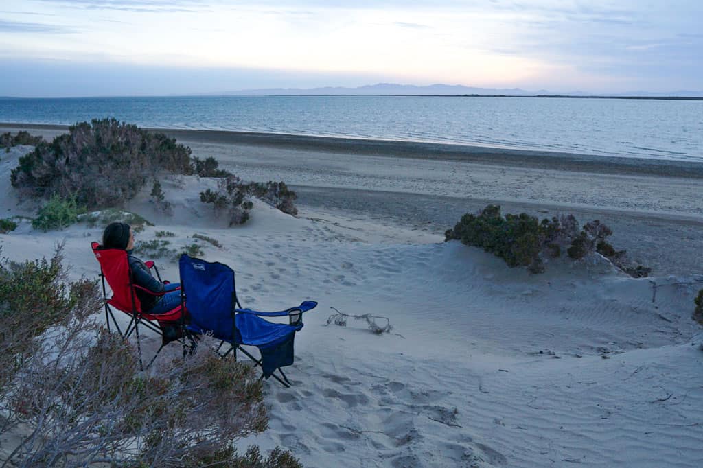 woman in camping chair watching sunset