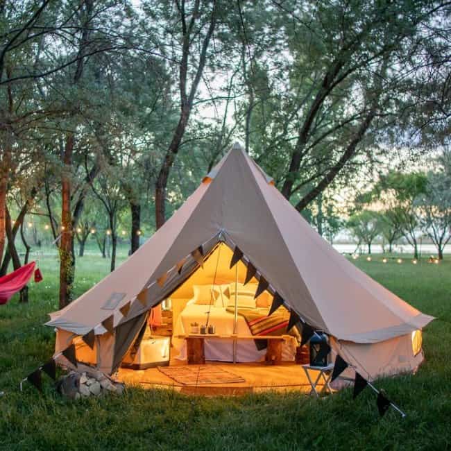 The Teton Sports Sierra Tent in the woods with light inside