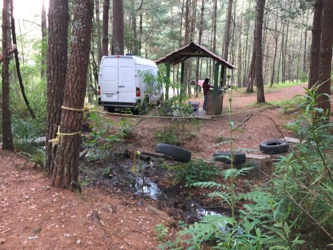 Our campsite by the stream with an adventure tire course and sheltered grilling area in Ixtepeji camping